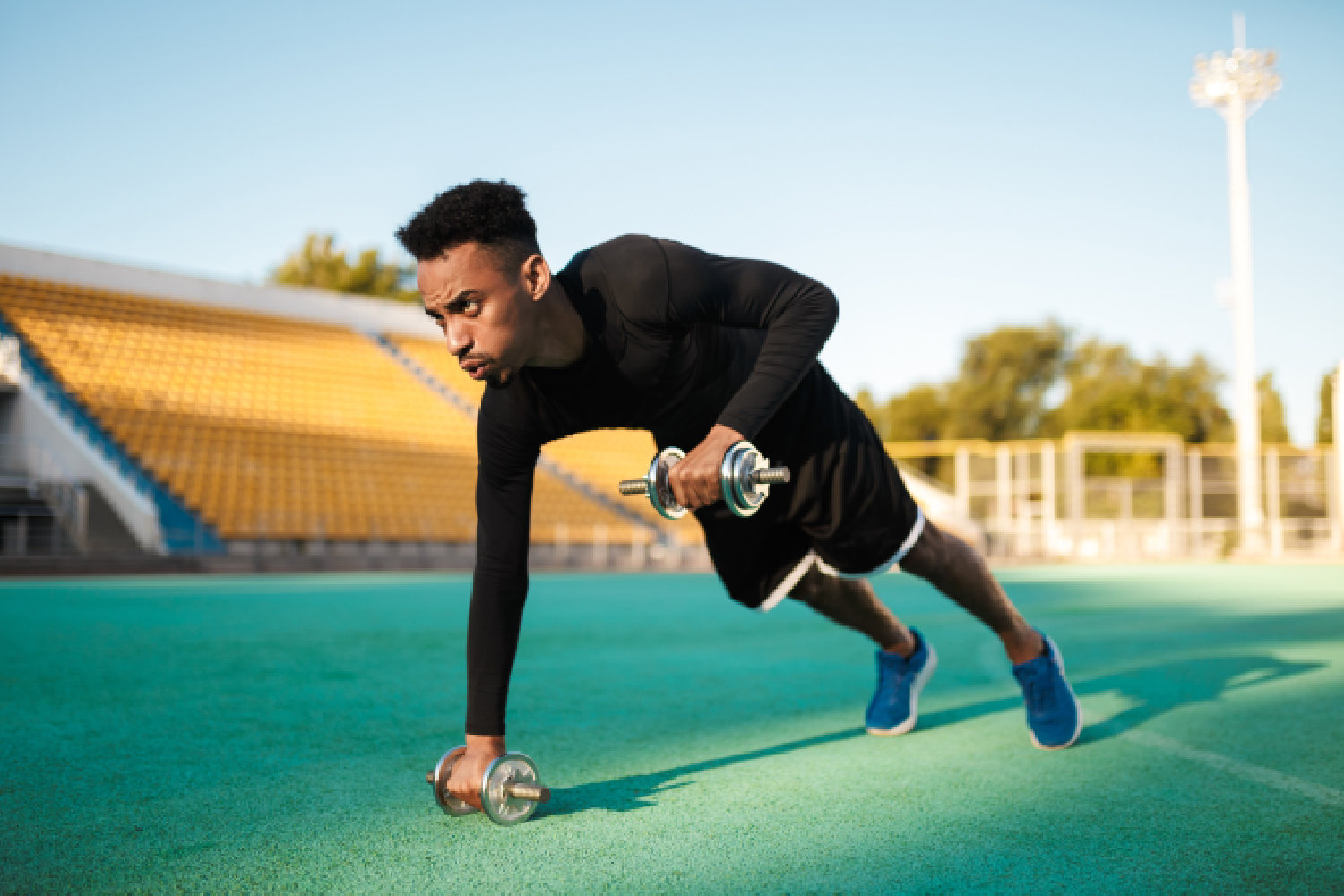 An athlete performing explosive start drills on the track at our athletics training academy Seoni.