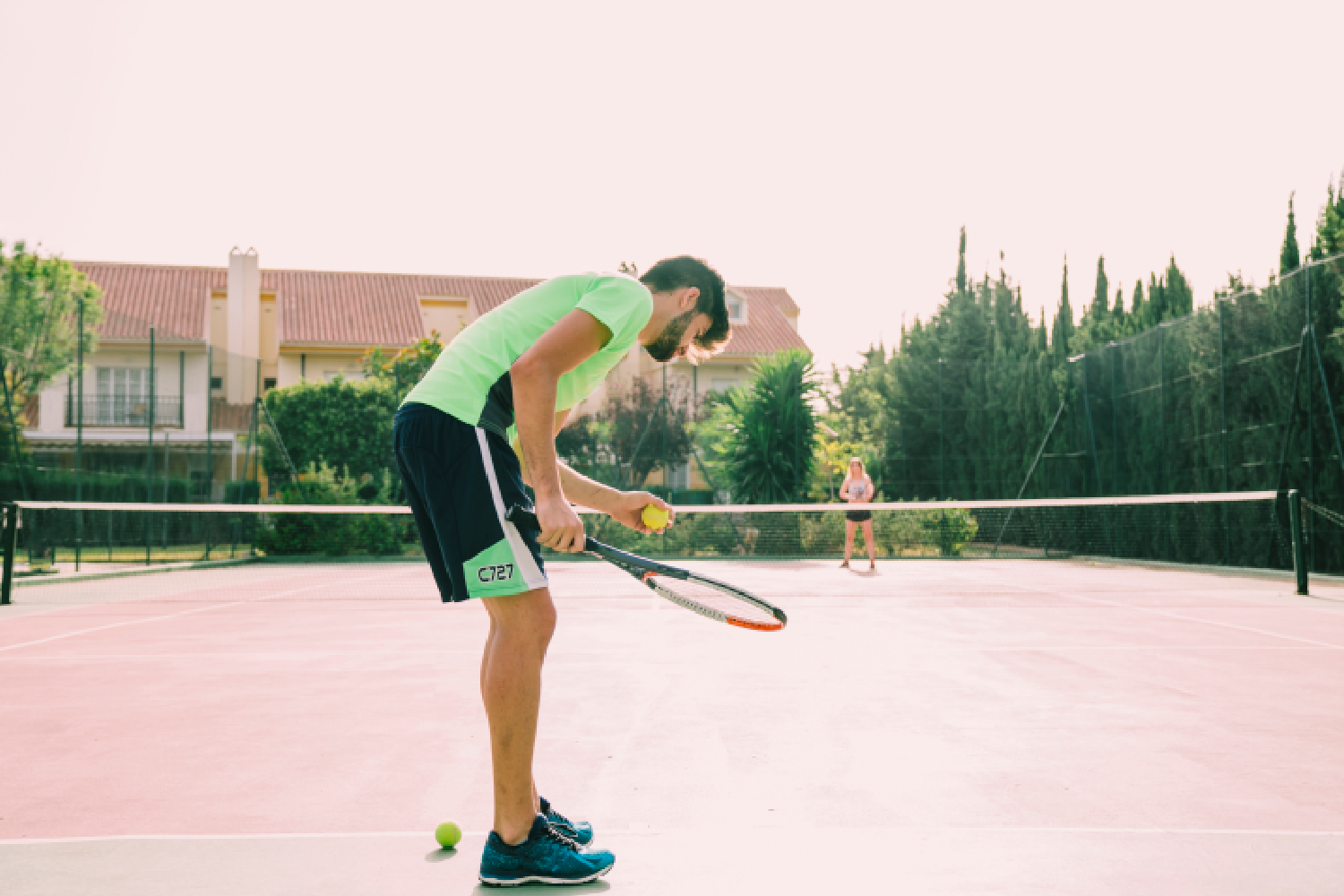An athlete practicing a powerful baseline forehand during lawn tennis training Seoni.